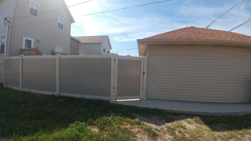Photo of an offset vinyl PVC gate and fence designed and installed by First Fence