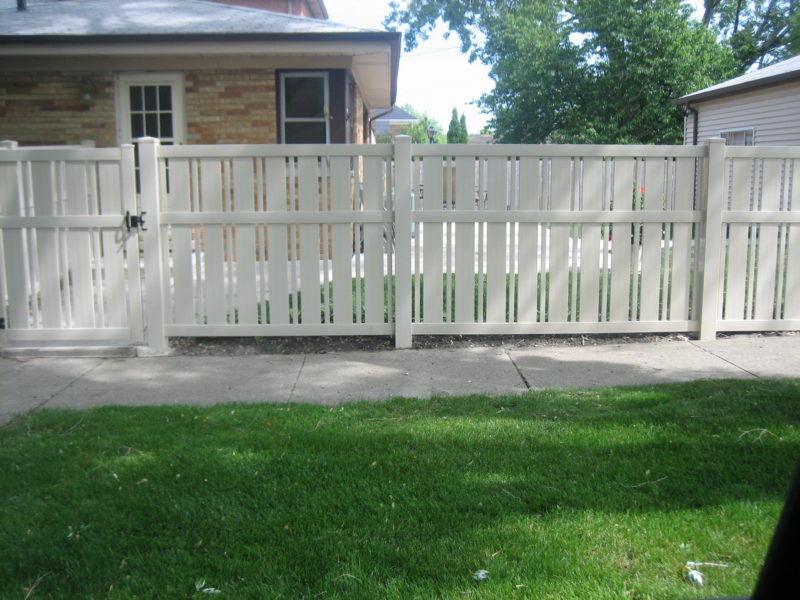 Photo of a White PVC Moline Sand style vinyl fence designed and installed by First Fence