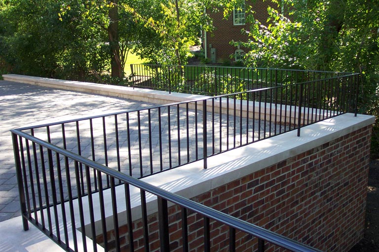 Photo of custom powder-coated iron railing atop a second story balcony