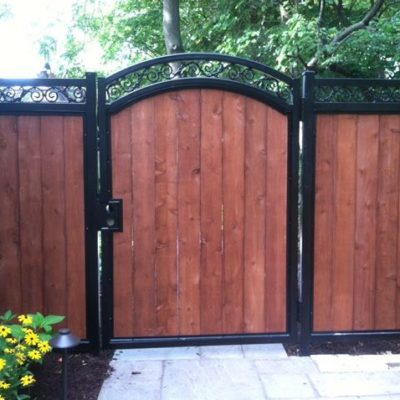 Photo of an iron and wood fence and gate designed and installed by First Fence Company