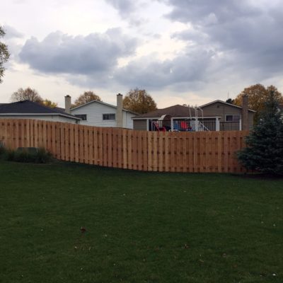 Photo of a shadowbox wood fence that follows the grade installed by First Fence Company