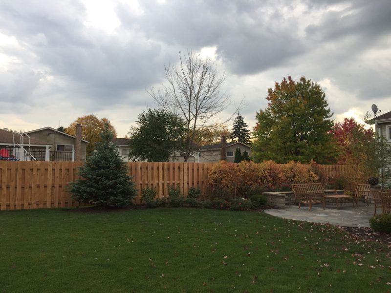 Photo of a shadowbox wood fence that follows the grade installed by First Fence Company