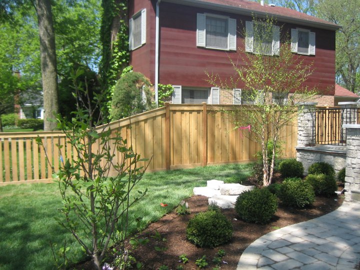 Board on Board wood fence with smaller transition installed by First Fence Company