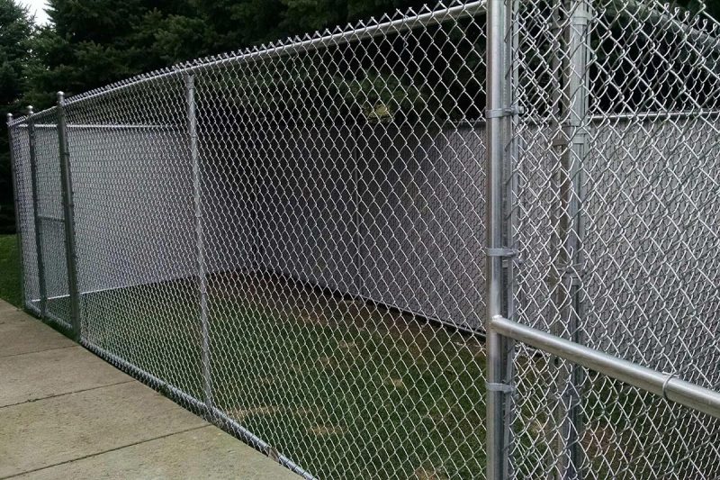 Photo of a custom chain link dog fence installed by First Fence Company in Hillside, IL