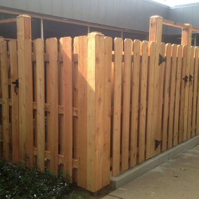 Photo of a custom courtyard enclosure fence installed by First Fence