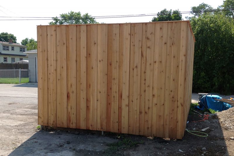 Photo of custom commercial garbage enclosure installed by First Fence