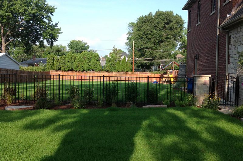 Photo of a custom residential masonry iron fence installed by First Fence