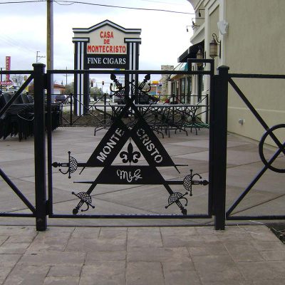 Photo of a custom iron laser cut logo iron fence system - First Fence