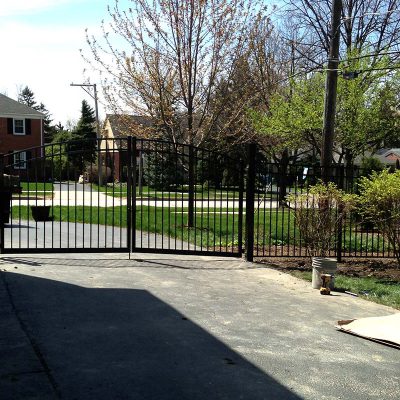 Photo of a custom follow the grade gate installed by First Fence