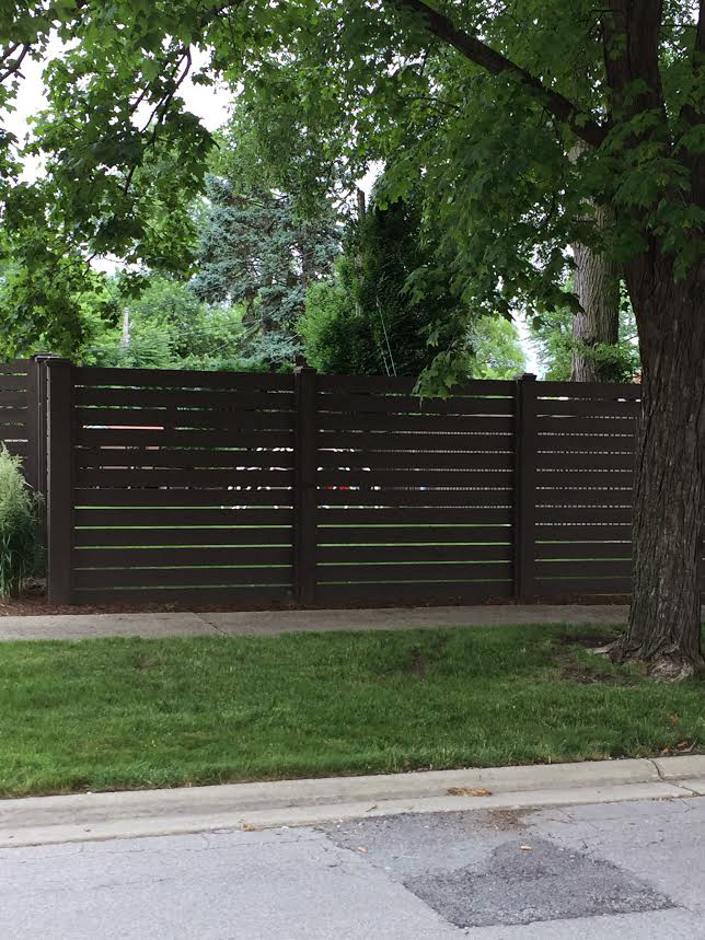 Photo of a custom horizontal stained wood fence installed by First Fence Company