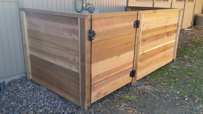 Photo of a custom horizontal stained wood HV/AC enclosure installed by First Fence Company