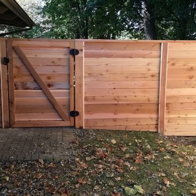 Photo of a custom horizontal wood fence and gate designed and installed by First Fence Company in Hillside, IL