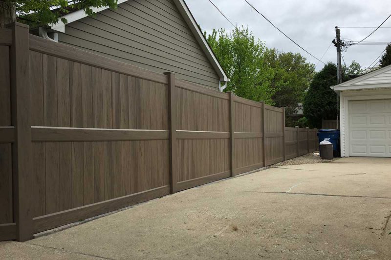 Photo of residential green teak vinyl pvc fence - First Fence