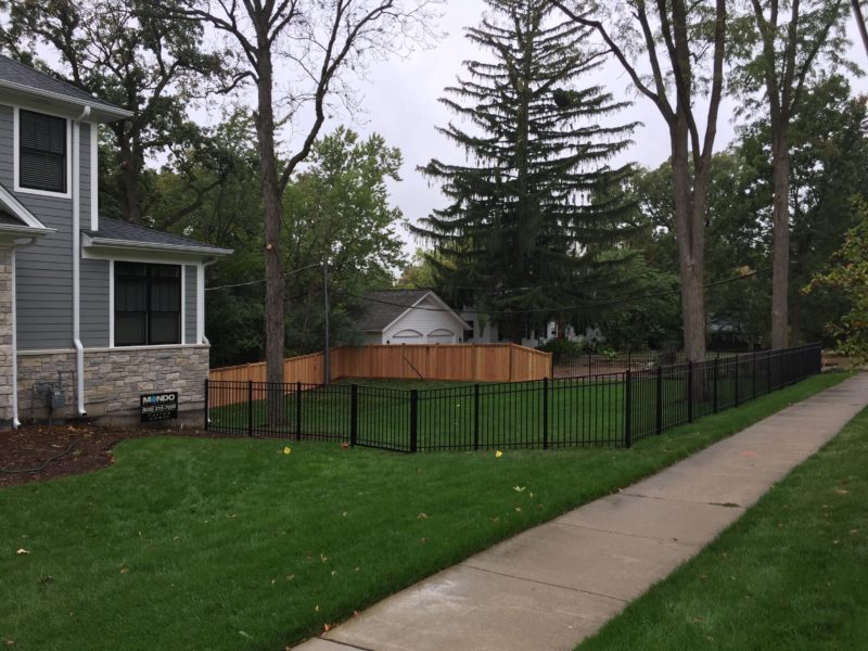 Aluminum and Wood fences installed by First Fence Company